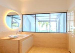 un bagno con un lavandino e una grande finestra di Suntai Villa, Beachfront Suites a Kampong Si Ginting Altre 30 foto