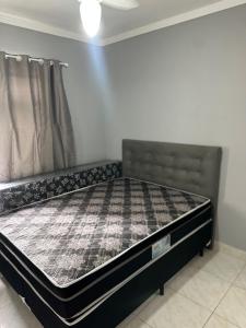 a bed sitting in a room with a mattress at Apartamento canto do forte in Praia Grande