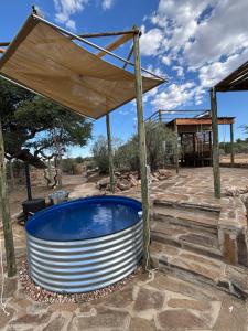 a hot tub under a canopy on a patio at BellaTiny Campsite with camping cabin for 4 in Windhoek