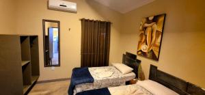 a small room with two beds and a mirror at Casa do Galego no Residência Família in Canoa Quebrada +29 photos