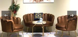 a living room with two chairs and a table at Tranquility luxury hotel and apartment in Rubuchi