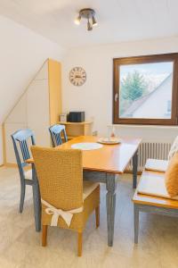 a dining room with a table and chairs at Fewo Mainau in Unteruhldingen