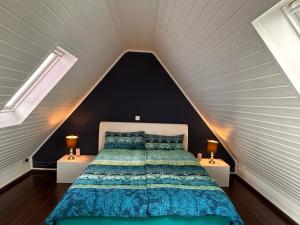 a bedroom with a large bed in a attic at Sonnendeck - Wellness Whirlpool Garden & Grill,125qm in Meerbusch