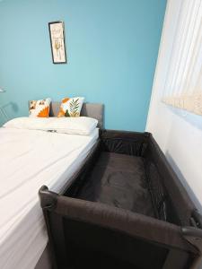 an empty bed in a room with avertisementatronatronatronstrationstrationstrationstration at City Center Balcony by the Universities in Manchester