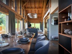 a dining room with a long table and chairs at Chalet RevAlp - OVO Network in Combloux +29 photos