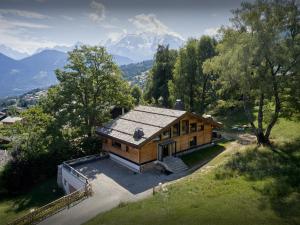 an overhead view of a house with mountains in the background at Chalet RevAlp - OVO Network in Combloux