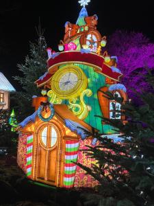 a large clock tower is lit up at night at Suite Familiale "Comme à Venise" Metz-Opéra 4 étoiles in Metz