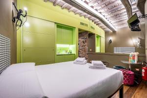 a large bed in a room with green walls at Pop Tower Florence in Florence