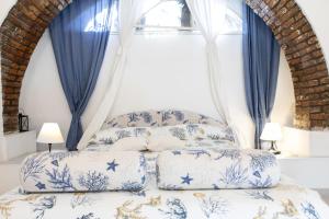 een slaapkamer met een blauw en wit bed en een raam bij Villa Daniela Vista Mare - 70metri dalla Spiaggia - WiFi - Free Parking in Terracina