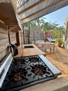 a outdoor kitchen with a stove and a patio at Surf Retreat La Saladita, Yoga, Pool, Templo, Casita Sol in La Majahua +25 photos