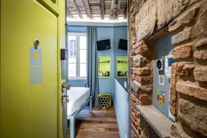 a room with a yellow door and a brick wall at Pop Tower Florence in Florence