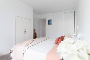 a white bedroom with a bed with white walls at Casa Tabera - Sun Club Playa del Águila in Playa del Aguila +27 photos