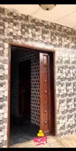 a room with a brick wall with a door in it at APARTMENT for RENT in Baruwa