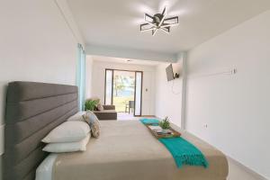a bedroom with a large bed in a room at Beachfront Studio in Aguada in Aguada