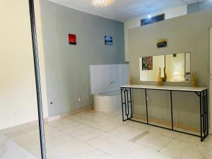 a bathroom with a counter and a mirror and a tub at SAISH Stay in Ruhengeri