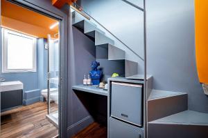 a bathroom with a staircase and a sink and a toilet at Pop Tower Florence in Florence