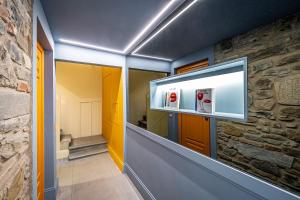 a hallway with a stone wall and a fire hydrant at Pop Tower Florence in Florence +109 photos