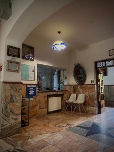 a room with two chairs and a fireplace and a light at Hotel Europa in Polanica-Zdrój