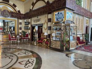 a lobby of a palace with red chairs at Al Safa Royal Suites in Doha
