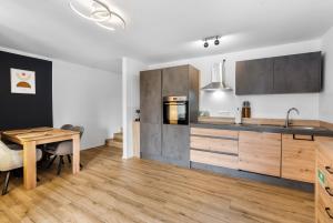 a kitchen with wooden cabinets and a wooden table at TM Stays - NIVIS - Gemütliches Apartment mit Terrasse & Garten - Ruhe, Natur, Wandern, Ski in Medebach