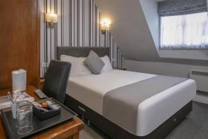 a hotel room with a bed and a desk with a drawer at Normanton Park Hotel, BW Signature Collection in Oakham +119 photos
