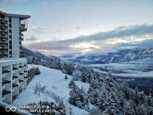 een uitzicht vanuit een hotel in de sneeuw bij Apartment Kandahar 42 in Crans-Montana