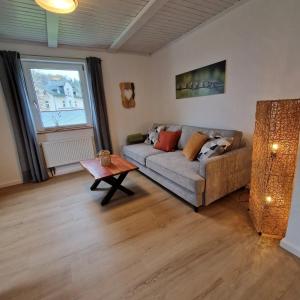 a living room with a couch and a table at Ferienwohnung Gartenblick in Eslohe