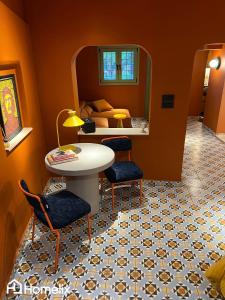 a room with a table and two chairs and a mirror at Santa Clara - the revolution of living in Chalkida