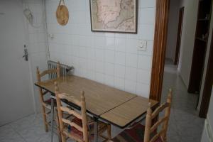 a wooden table and chairs in a room with a map on the wall at Toledo Downtown - Apartment for 6 in Toledo