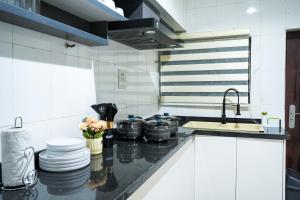a kitchen with pots and pans on a counter at Main Avenue Residence Lagos in Lagos +9 photos