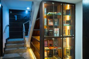 a book shelf filled with books next to a staircase at Main Avenue Residence Lagos in Lagos