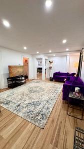 a living room with a purple couch and a rug at Perfect staycation in Ohio City, walk to W 25 st in Cleveland
