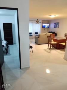 a living room with a table and a couch at Amplía casa en Jardines Alcalde in Guadalajara