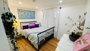 a small bedroom with a crib with purple pillows at Perfect staycation in Ohio City, walk to W 25 st in Cleveland