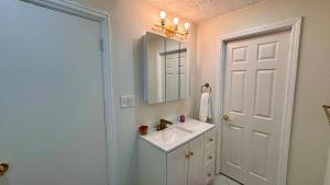 a white bathroom with a sink and a mirror at Perfect staycation in Ohio City, walk to W 25 st in Cleveland +38 photos