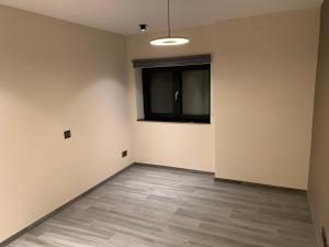an empty room with a window and a tiled floor at Ourthe Basse in La Roche-en-Ardenne