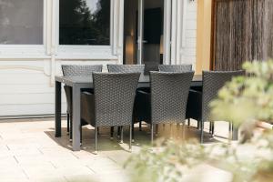 a table and chairs sitting on a patio at HEIMATEL - Rosenalm Scheidegg in Scheidegg