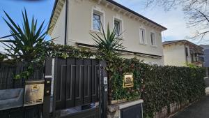 a house with a gate and a fence with plants at Superior Suite, Villa Joy Verona, Luxury Romantic Suite with Jacuzzi, near City Center in Verona