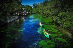 a group of people in kayaks on a river at Studio Cozy in La Celle-sous-Gouzon