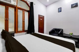 a bedroom with two beds and a window at HOTEL O STAY INN Lucknow Airport VIP Terminal in Transport Nagar