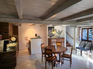 a kitchen and dining room with a table and chairs at Rustico Kevin by HolAp SA in Brissago