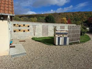 a fence with a wooden gate next to a building at Studio Cozy in La Celle-sous-Gouzon