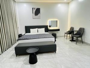 a bedroom with a bed and a table and chairs at MoHa Hotel in Hanoi