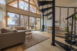 a living room with a couch and a spiral staircase at The Ffern in Logan +52 photos