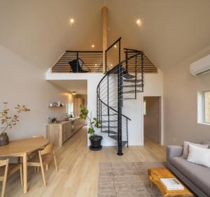 a living room with a spiral staircase in a loft at The Ffern in Logan