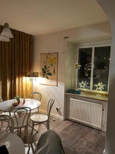a dining room with a table and chairs and a window at Anrika Svea Bed & Breakfast in Sala +14 photos