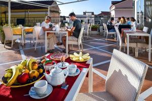 a tray of fruit on a table on a patio at Amalfi Suite Boutique Hotel in Amalfi