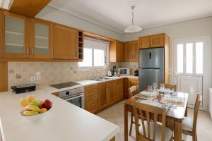 a kitchen with a table with a bowl of fruit on it at Vasilopoulos Residences - Apartments Ioni & Neso, Eliana & Melanthia in Argostoli