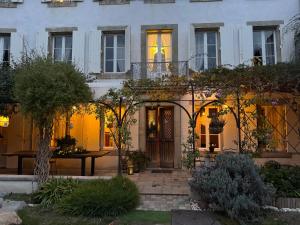 a house with a table in front of it at Le Patio Des Senteurs in Verzeille