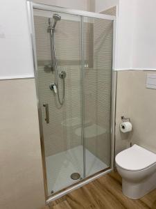 a shower stall in a bathroom with a toilet at Titti's Room in Casteldaccia
